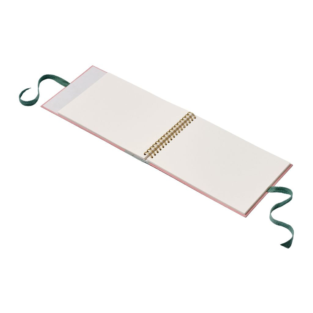 Open sketchbook with a green ribbon on a white background