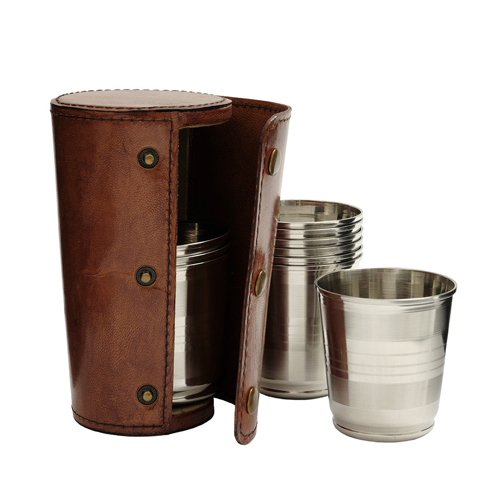 A set of stainless steel tumblers and a matching brown leather carrying case on a plain white background.