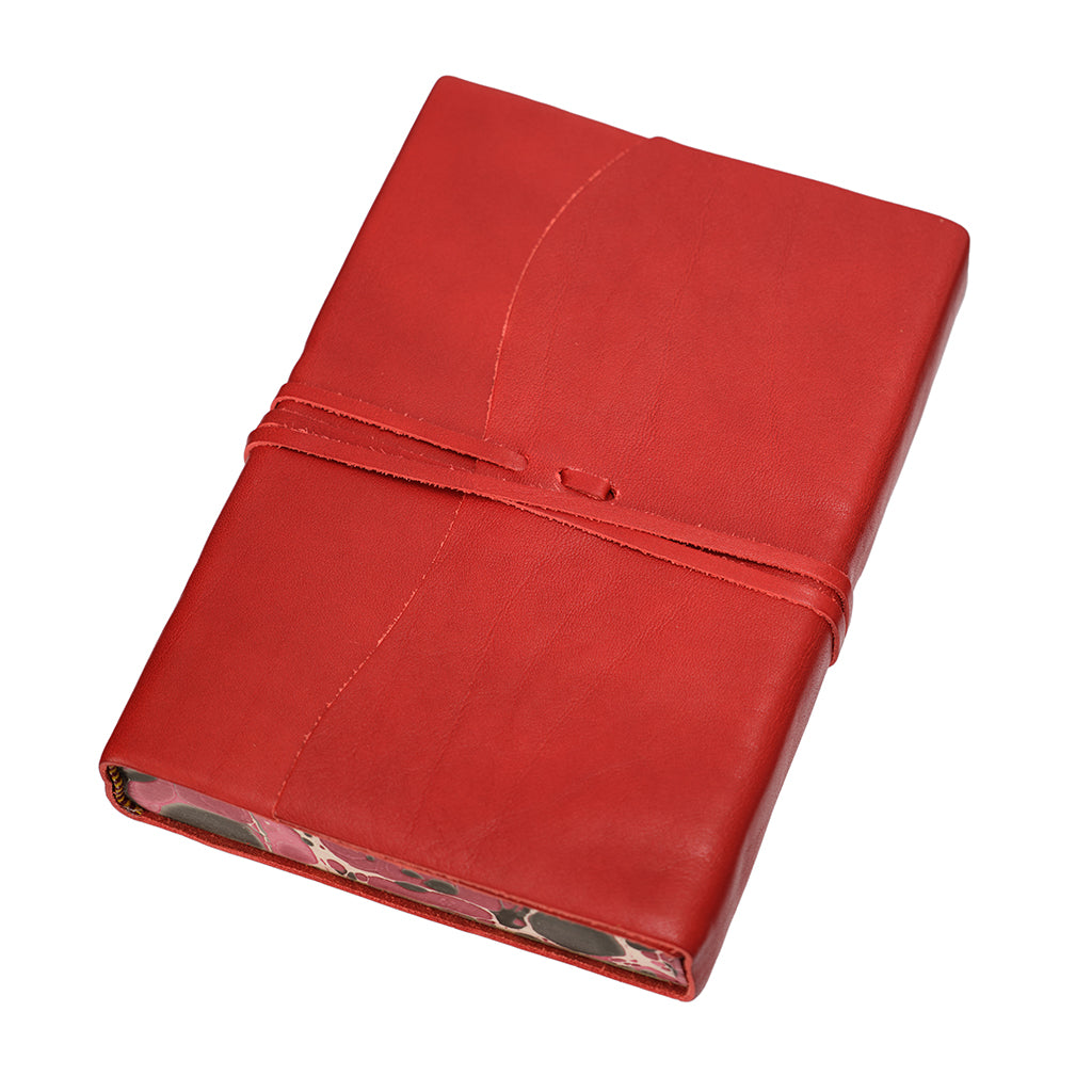 Red leather-bound notebook on a white background