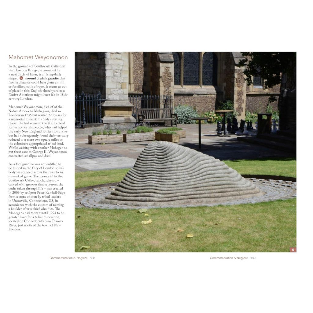 Stone sculpture in a garden with a building in the background