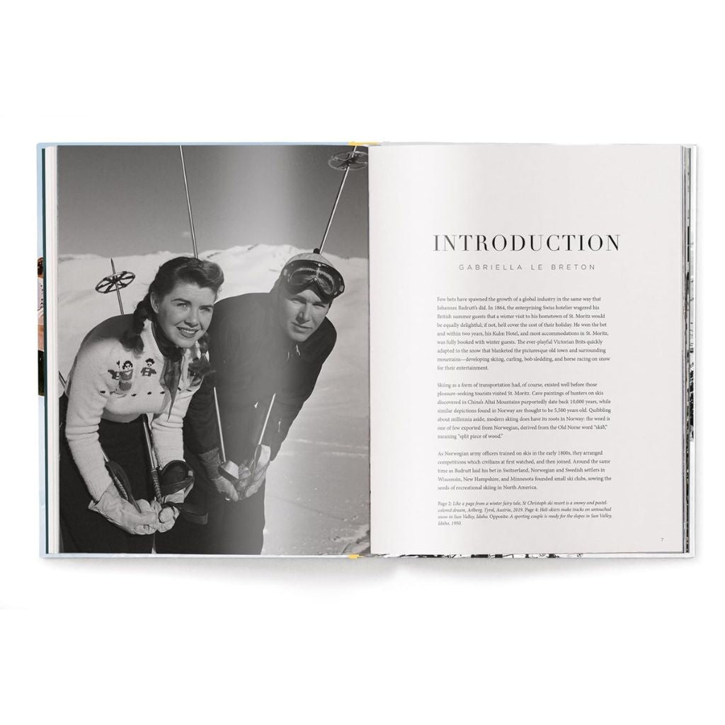 Open book showing a black and white photograph of two people on skis with an introduction text on the right page.