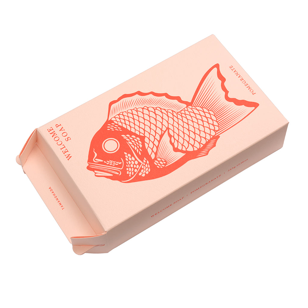 Pink box with a red fish illustration on a white background
