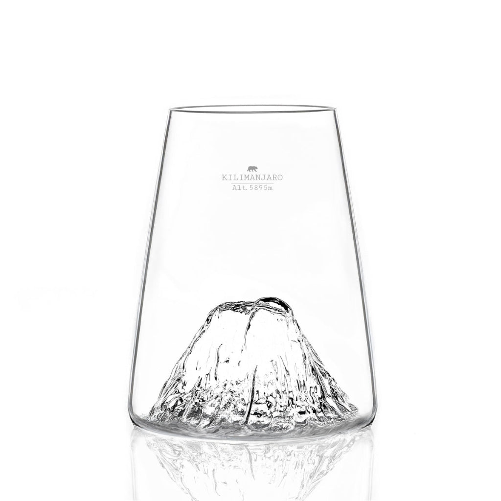 A clear glass tumbler set against a plain white background with a soft reflection below.