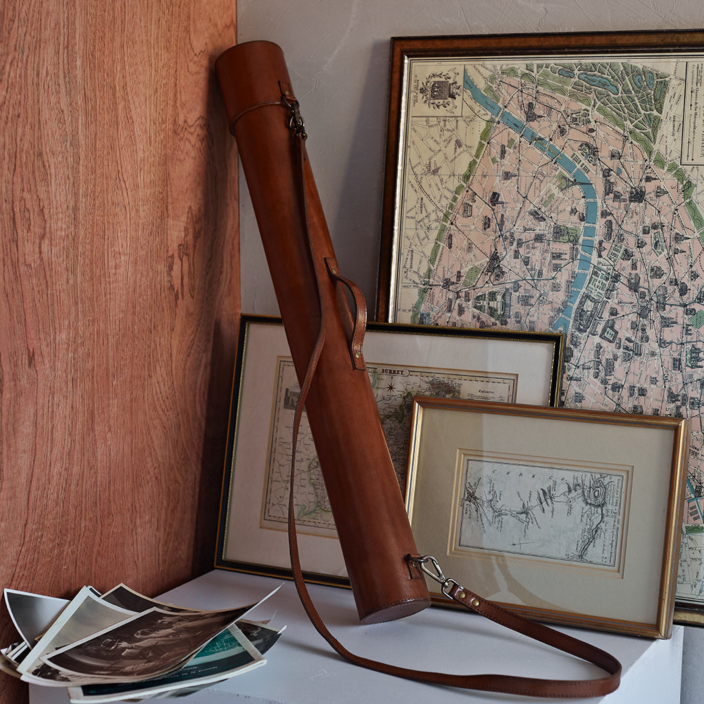Leather cylinder map cae standing up showing carrying strap