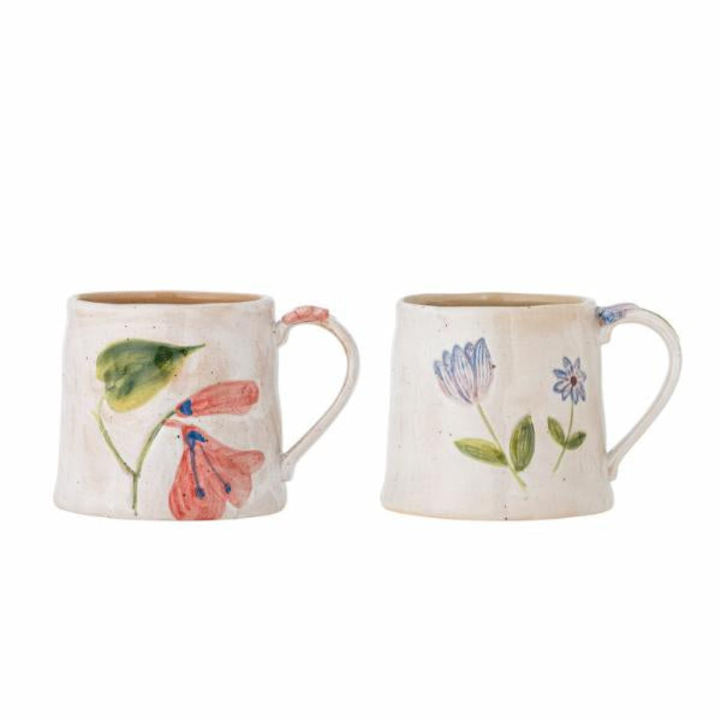 Two ceramic mugs with floral designs on a white background