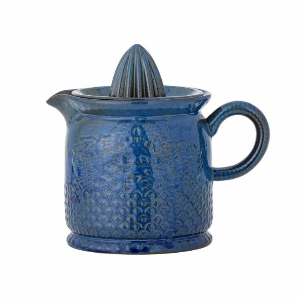 Blue ceramic juicer with a textured surface on a white background