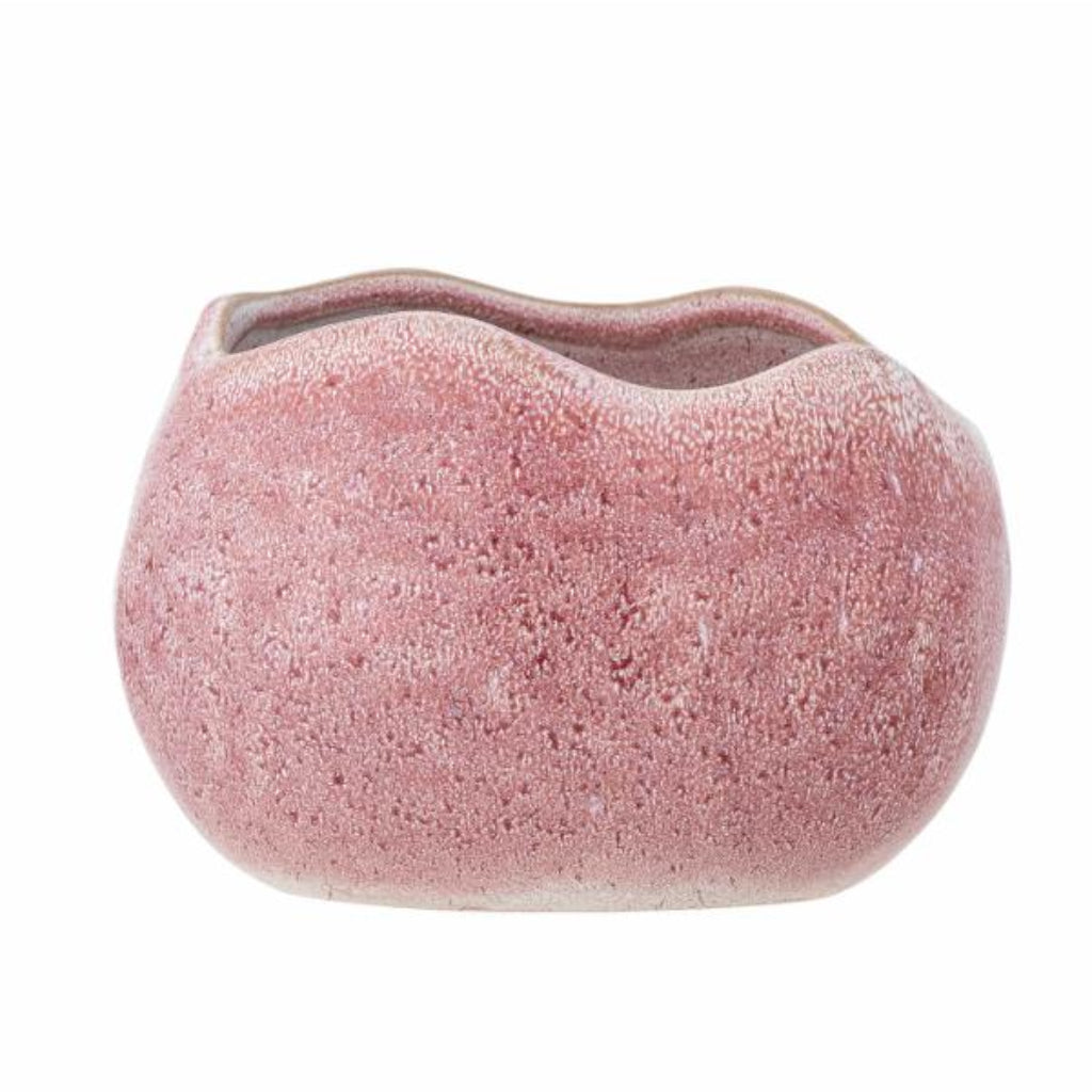 Pink textured vase on a white background