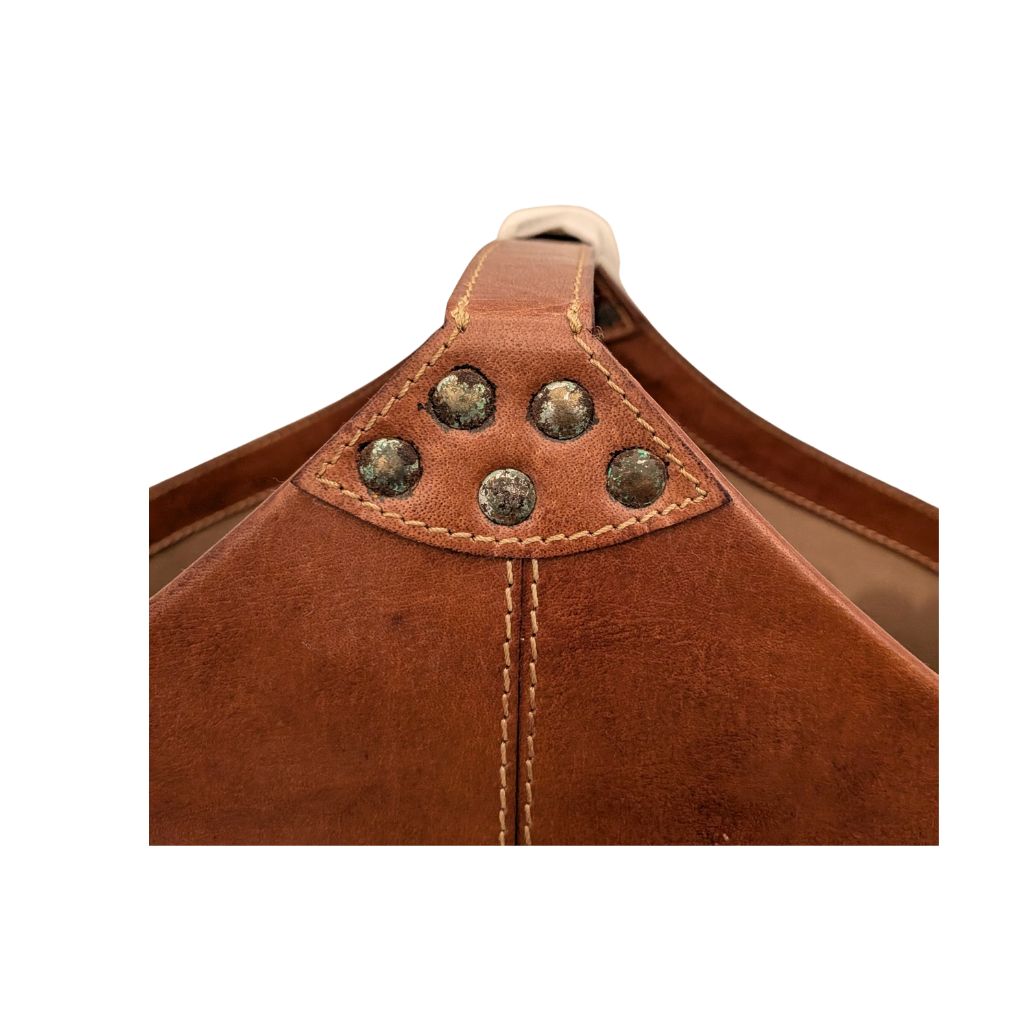 Close up of discoloration  to rivets of buckled magazine basket 
