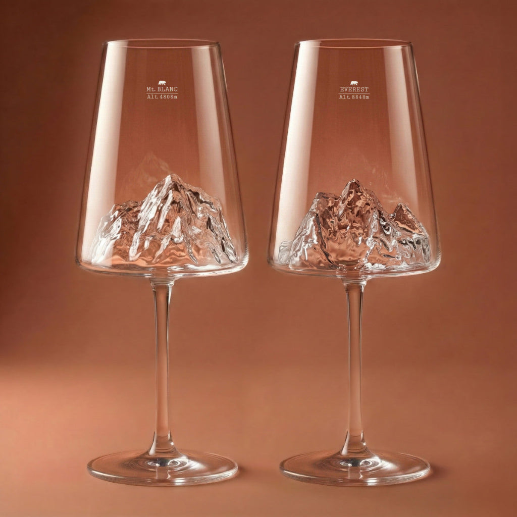 Two wine glasses with mountain etching on a brown background