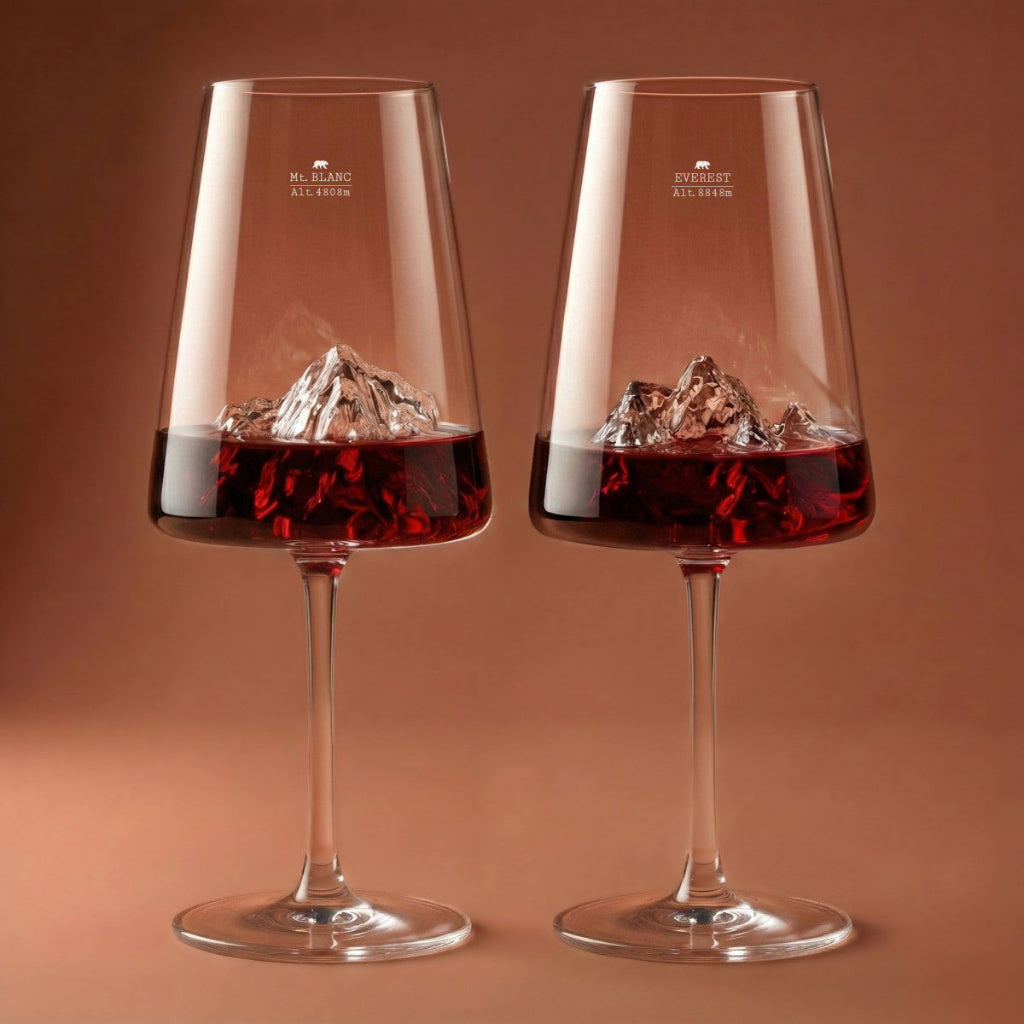 Two wine glasses with red wine and ice cubes on a brown background