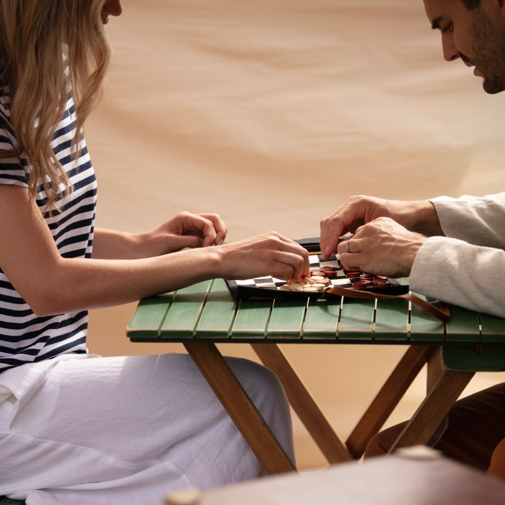 Waxed canvas travel chess being played  by couple 