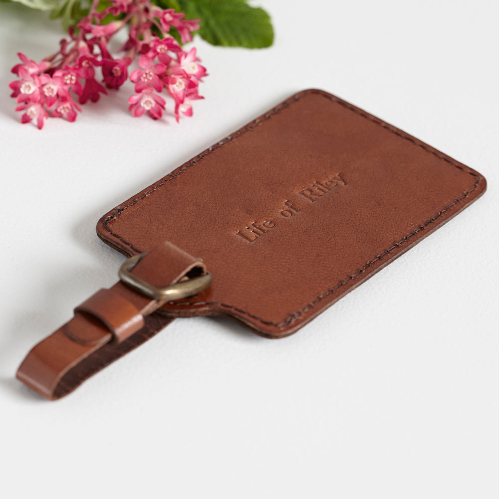 Personalised leather luggage tag, with embossing showing.